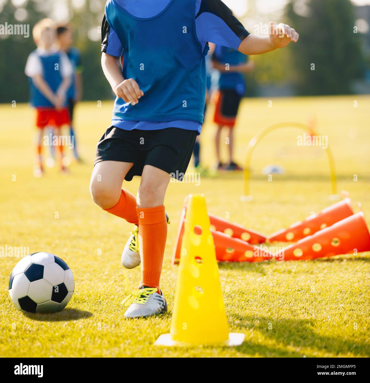 Boy Soccer Player In Training Drill. Young Soccer Players at Practice Session Stock Photo