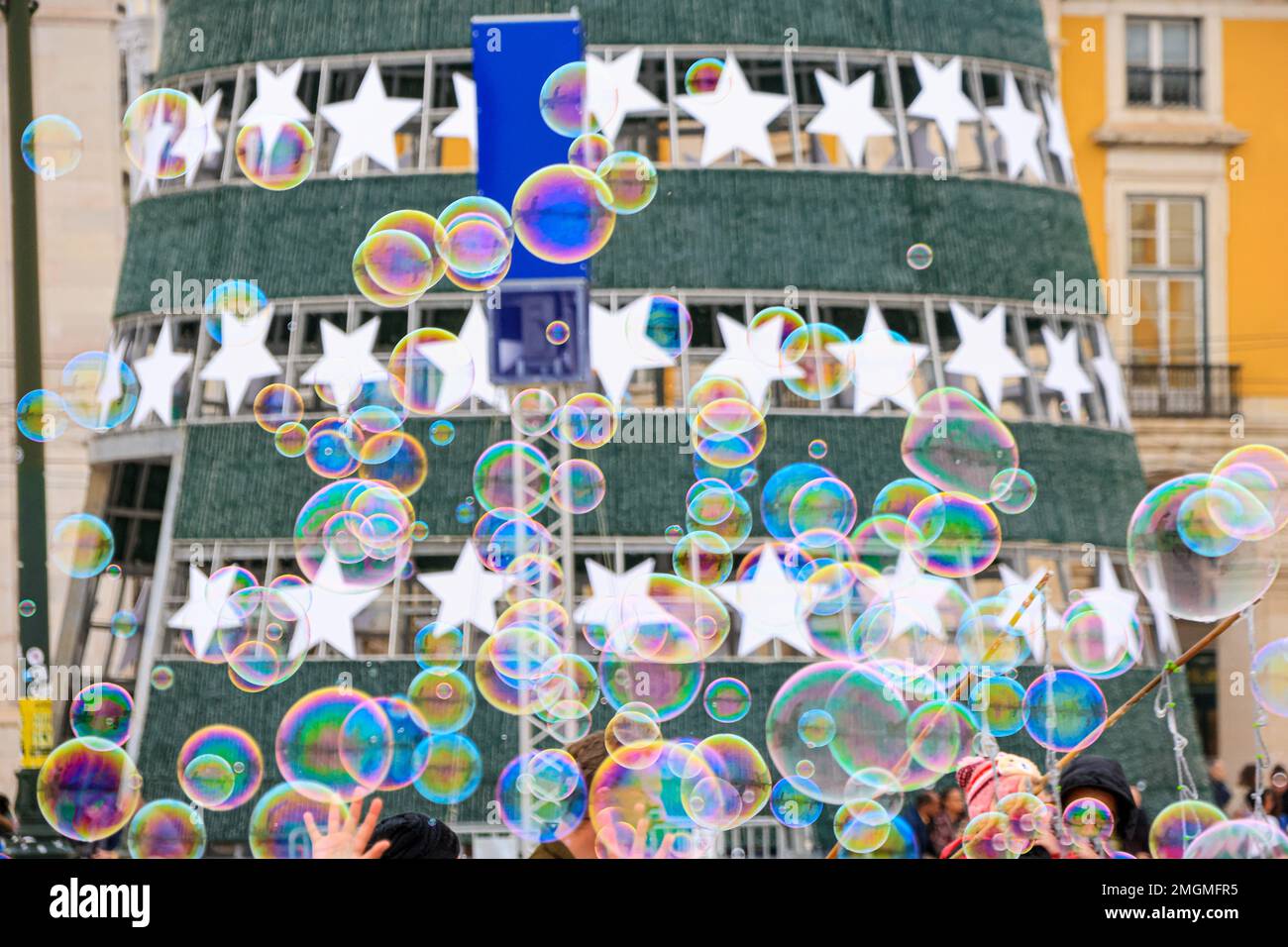 Giant soap bubbles next to the Christmas tree at Comercio square, Lisbon, Portugal Stock Photo