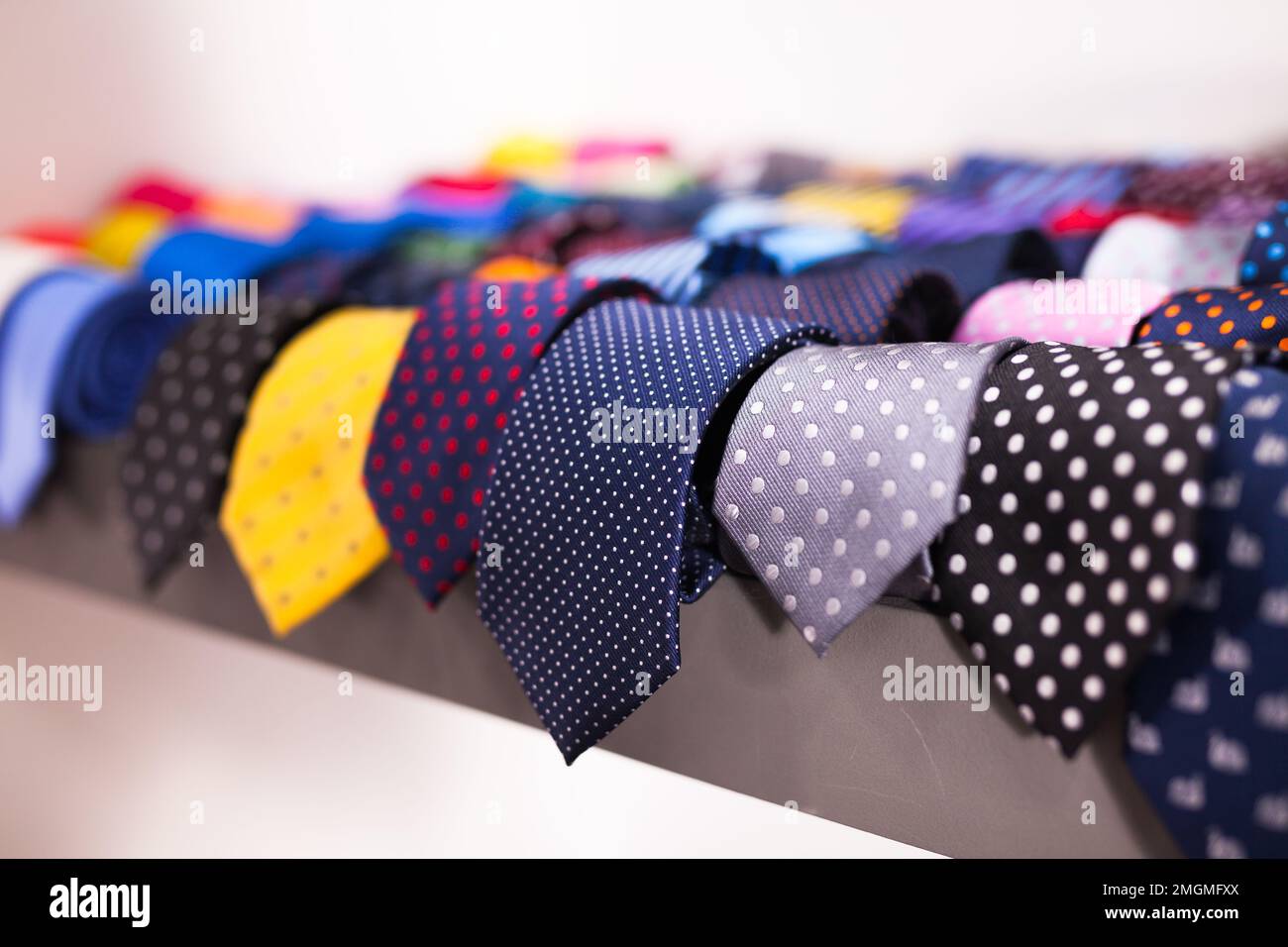 ties on hangers in men clothing store Stock Photo Alamy