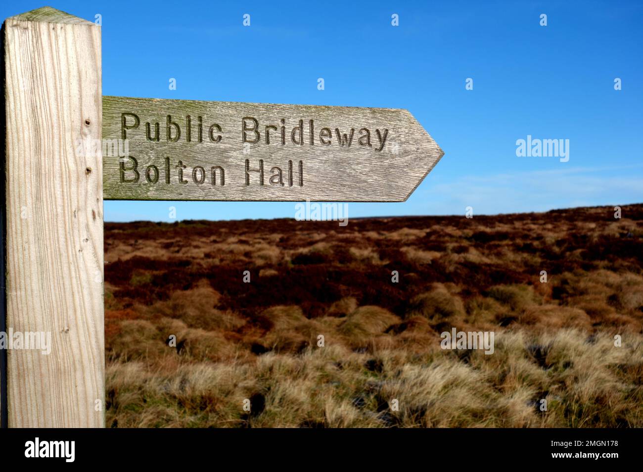 Wooden Signpost for Public Bridleway from Rlystone to Bolton Hall in the Yorkshire Dales National Park, England, UK. Stock Photo