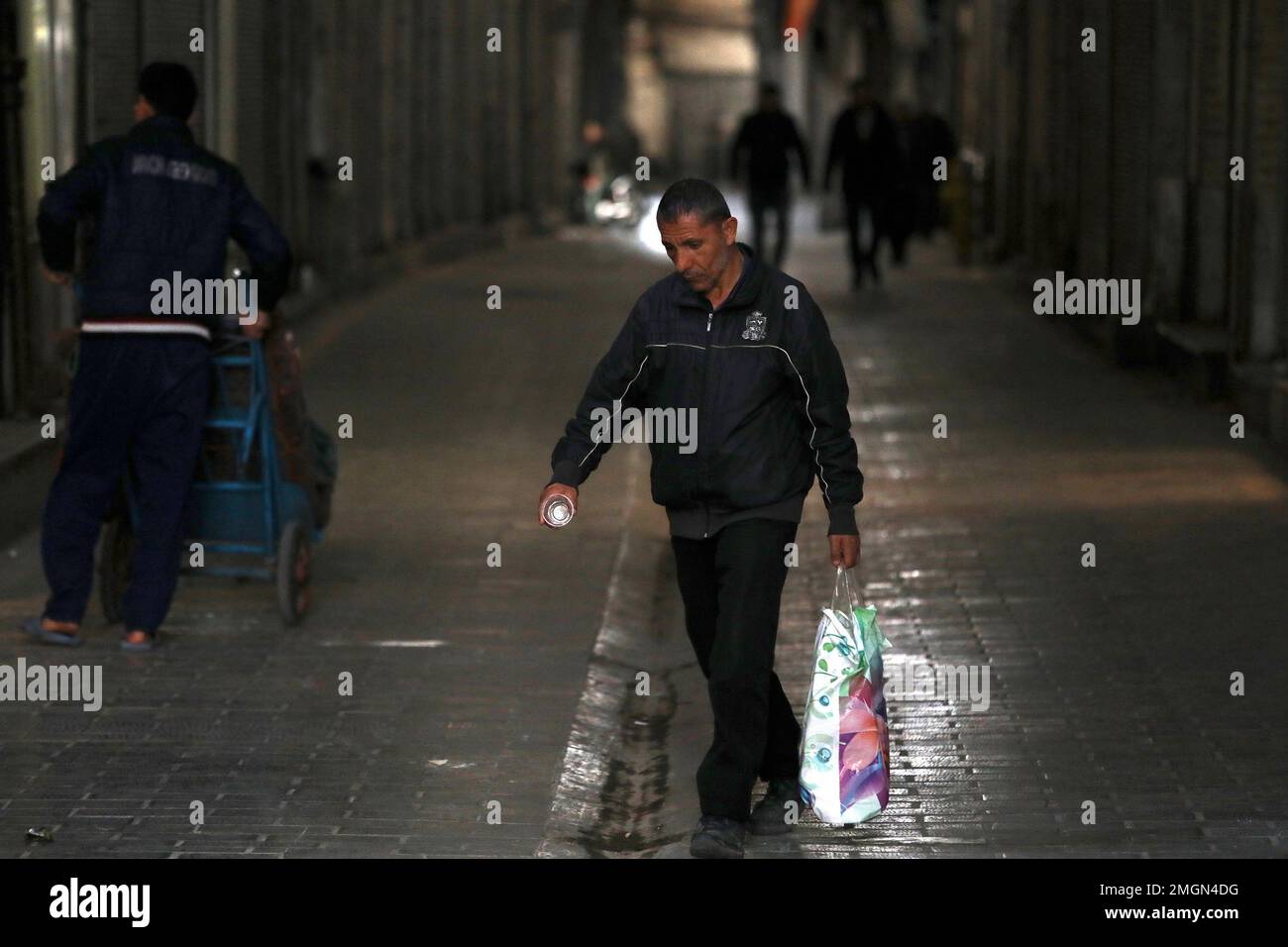 In this Tuesday, March 17, 2020, photo, people walk through the mostly closed Tehran's Grand