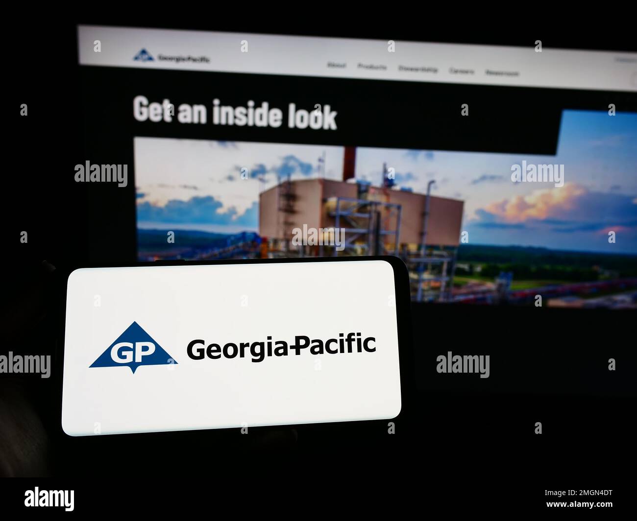 Person holding smartphone with logo of US pulp and paper company