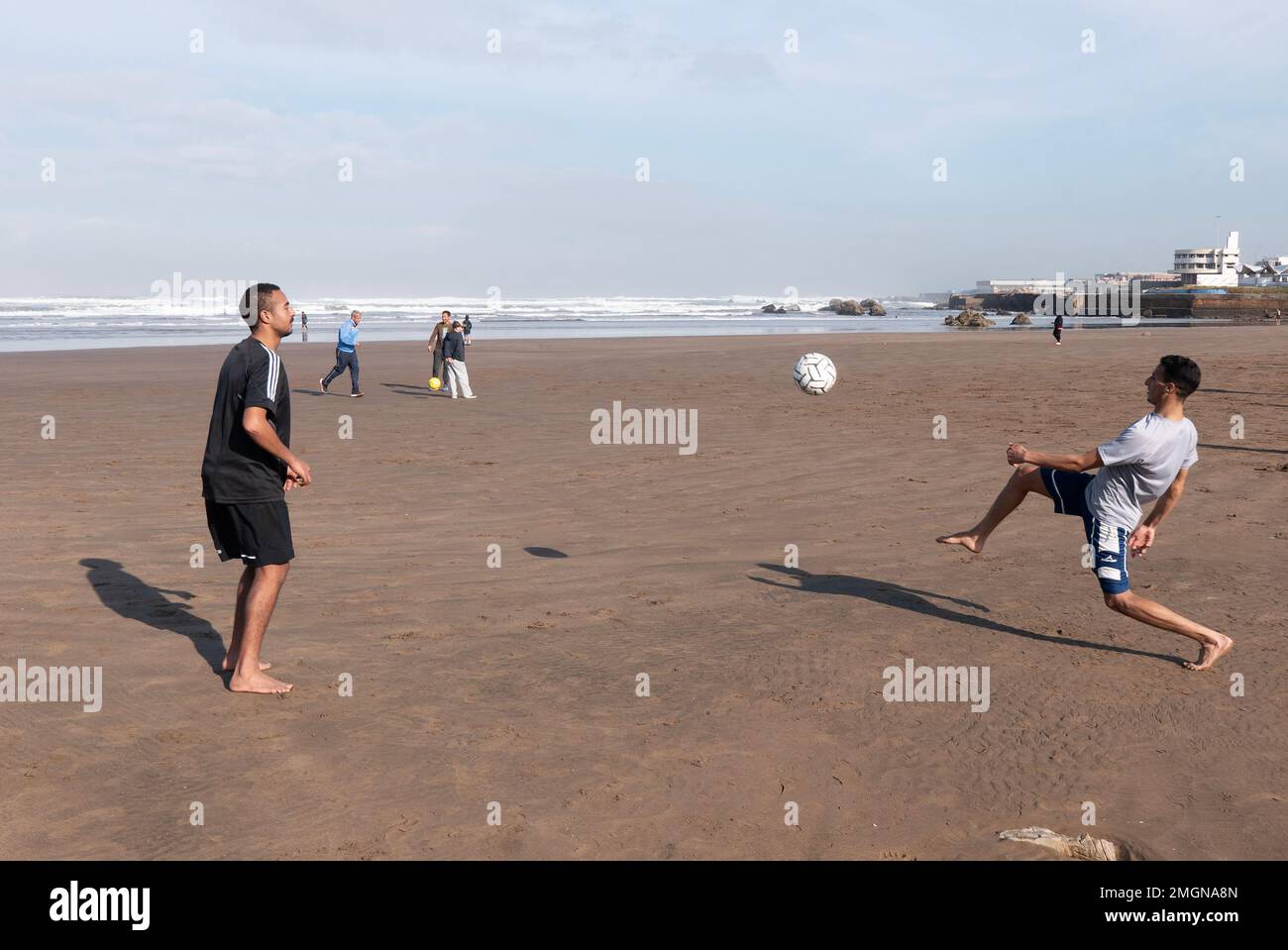 Football is big in Morocco, they got to World Cup semis, and everywhere they play, here on the beach at Casablanca for a break from work Stock Photo