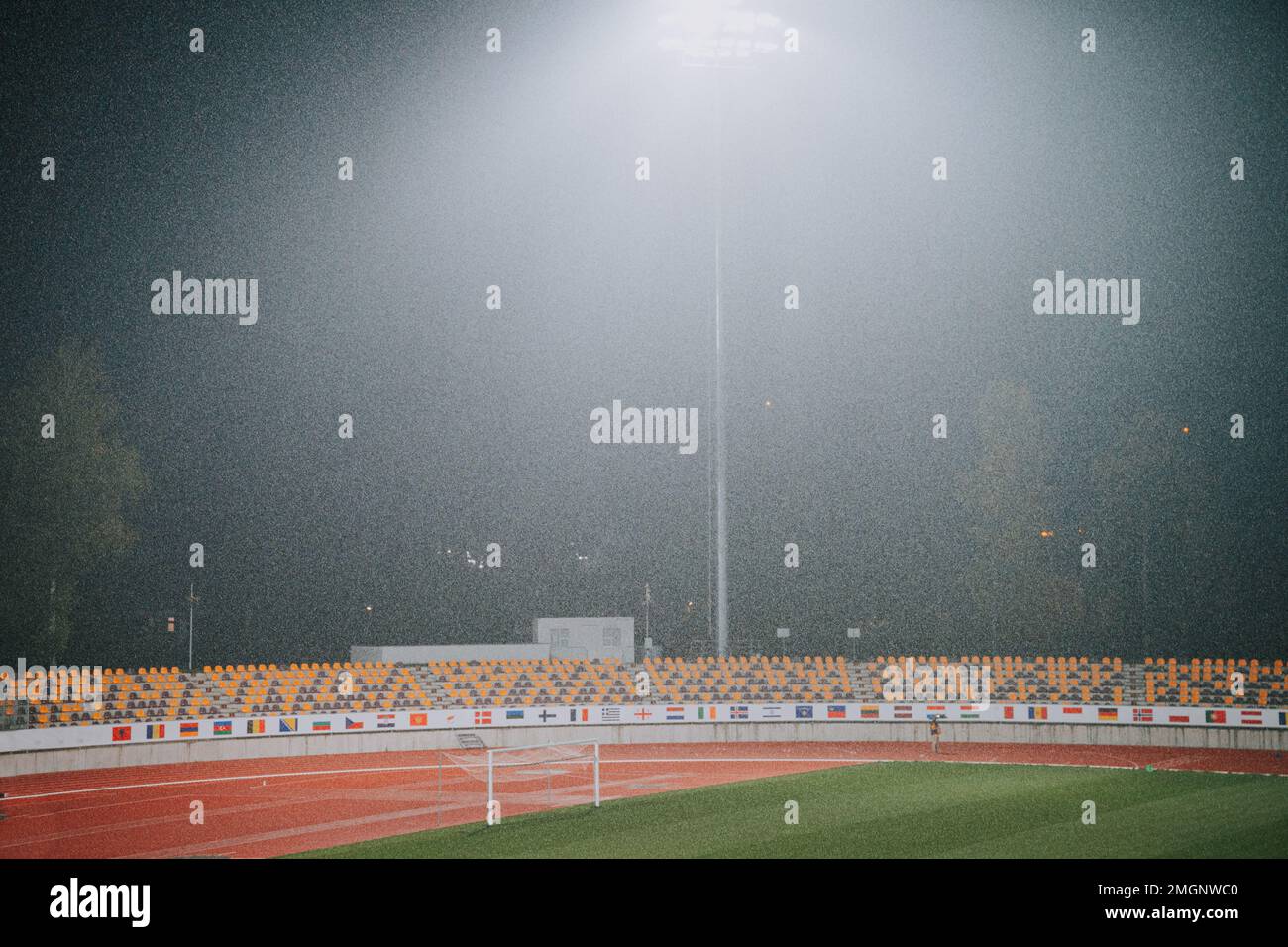 Athletics stadium in rainy weather, sport wallpaper Stock Photo Alamy