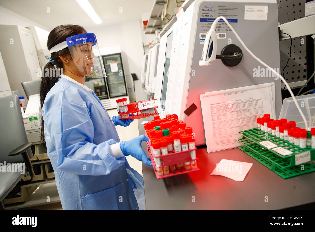 A laboratory technician prepares COVID19 patient samples for semi