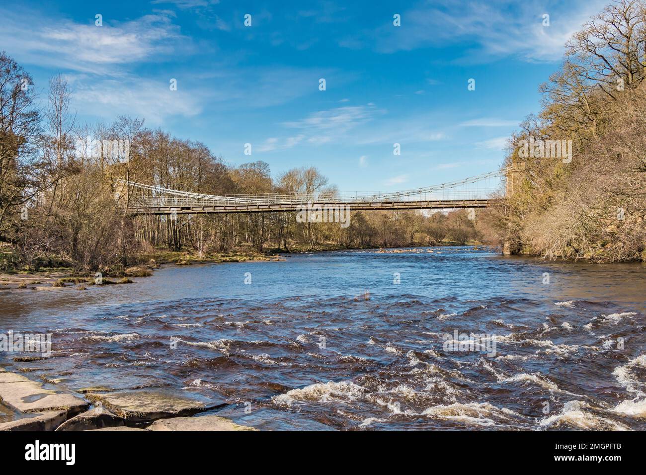 The Grade II listed and Scheduled Ancient Monument Whorlton suspension bridge, Teesdale in strong early spring sunshine. Stock Photo