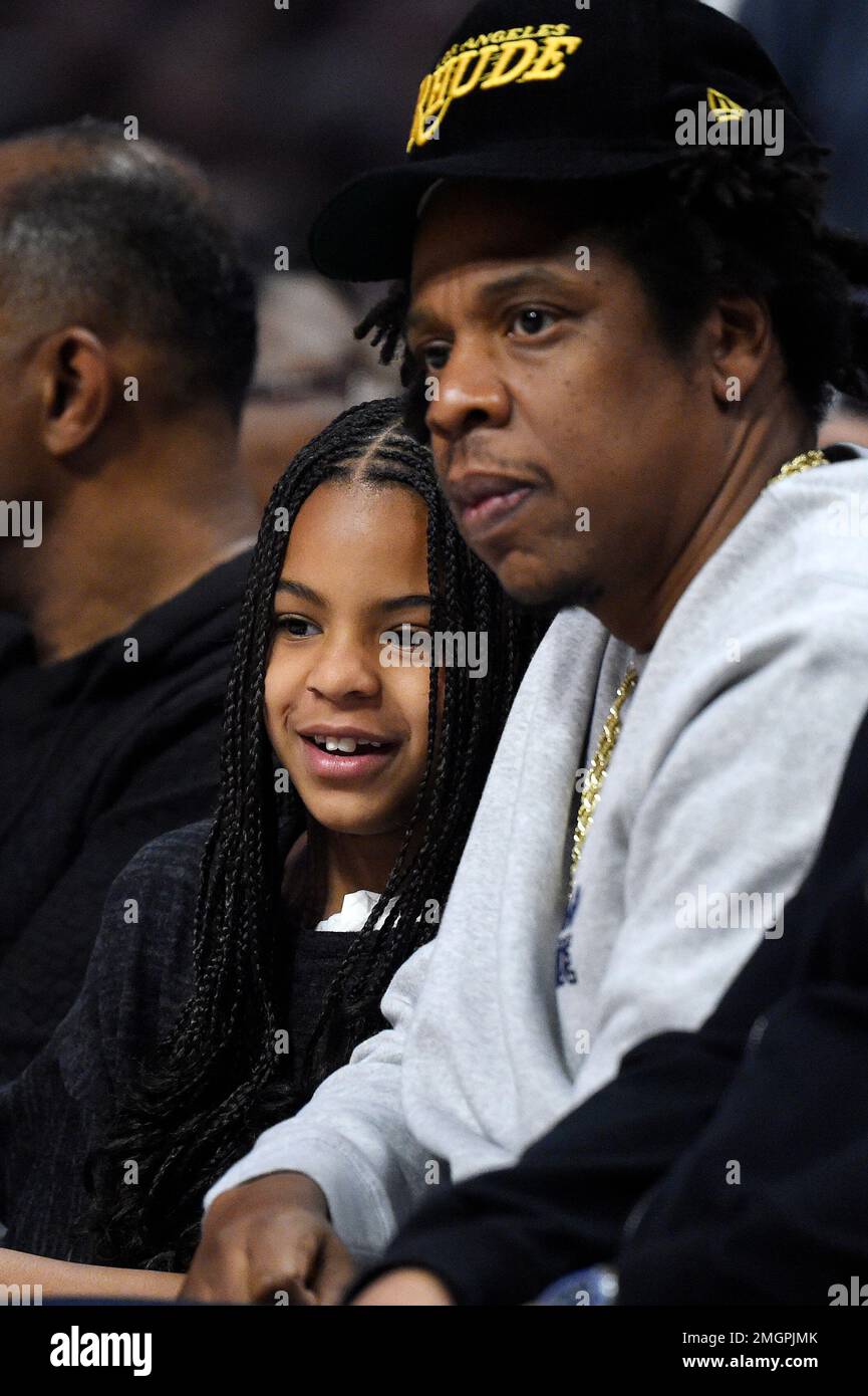 Rapper Jay-Z, right, sits with his daughter Blue Ivy during the second