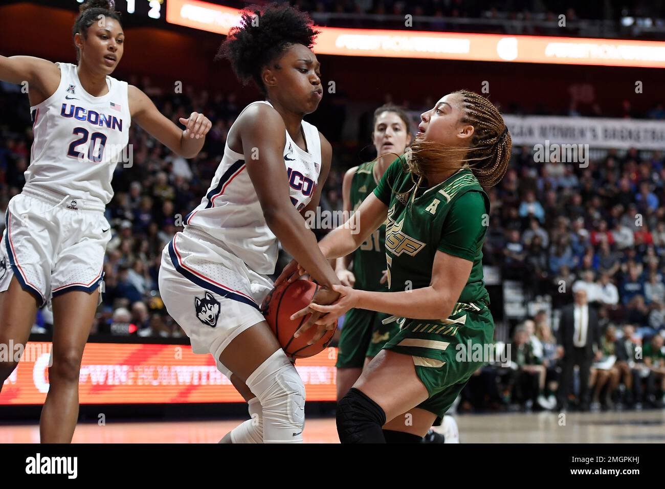 Connecticut's Christyn Williams, front left, strips the ball from South