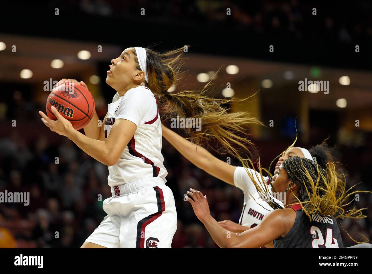 South Carolina's Victaria Saxton, left, drives to the basket while defended  by Arkansas' Taylah Thomas (24) during a semifinal match at the  Southeastern conference women's NCAA college basketball tournament in  Greenville, S.C.,