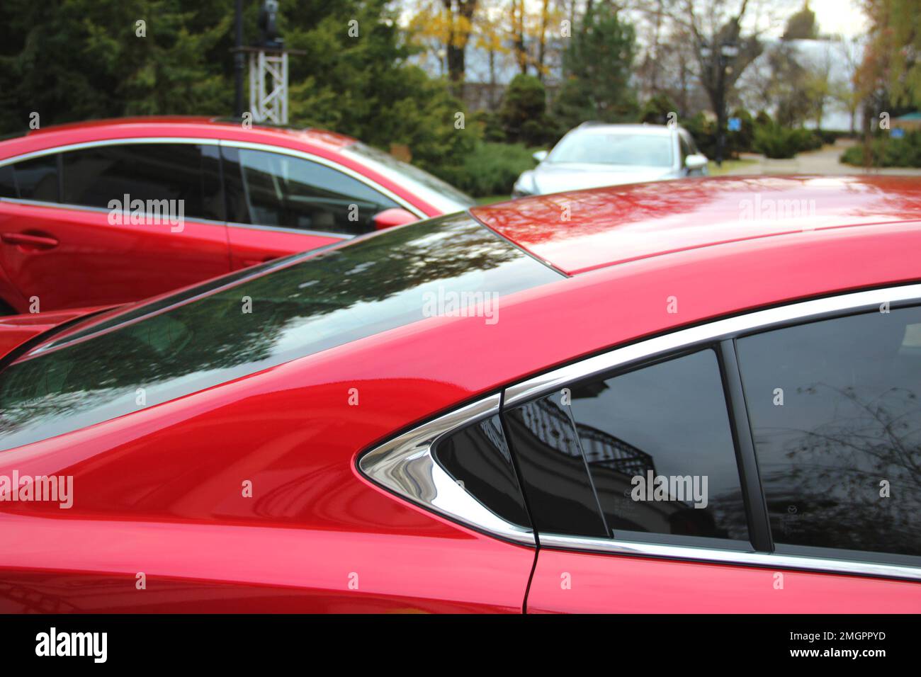 Vehicles On The Open Air Public Car Park At Evening Time Stock Photo
