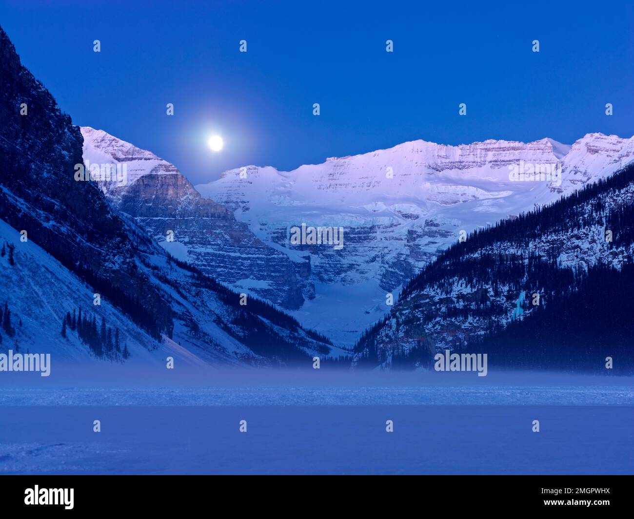 Moon rise on Lake Louise in winter Stock Photo - Alamy