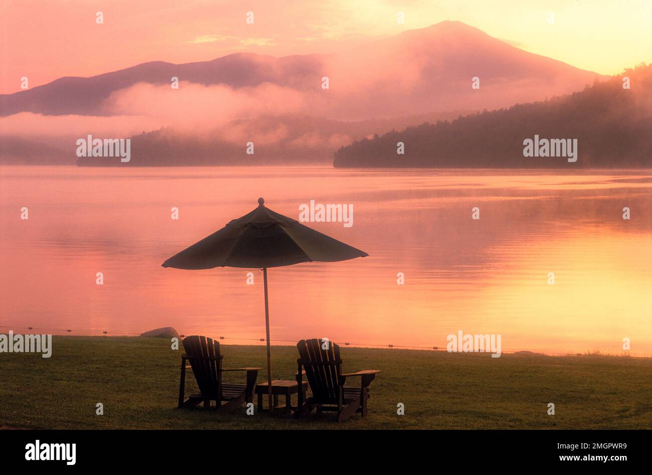USA New York, Lake Placid, Adirondack State Park. Adirondack chairs on Lake Placid at dawn Stock Photo