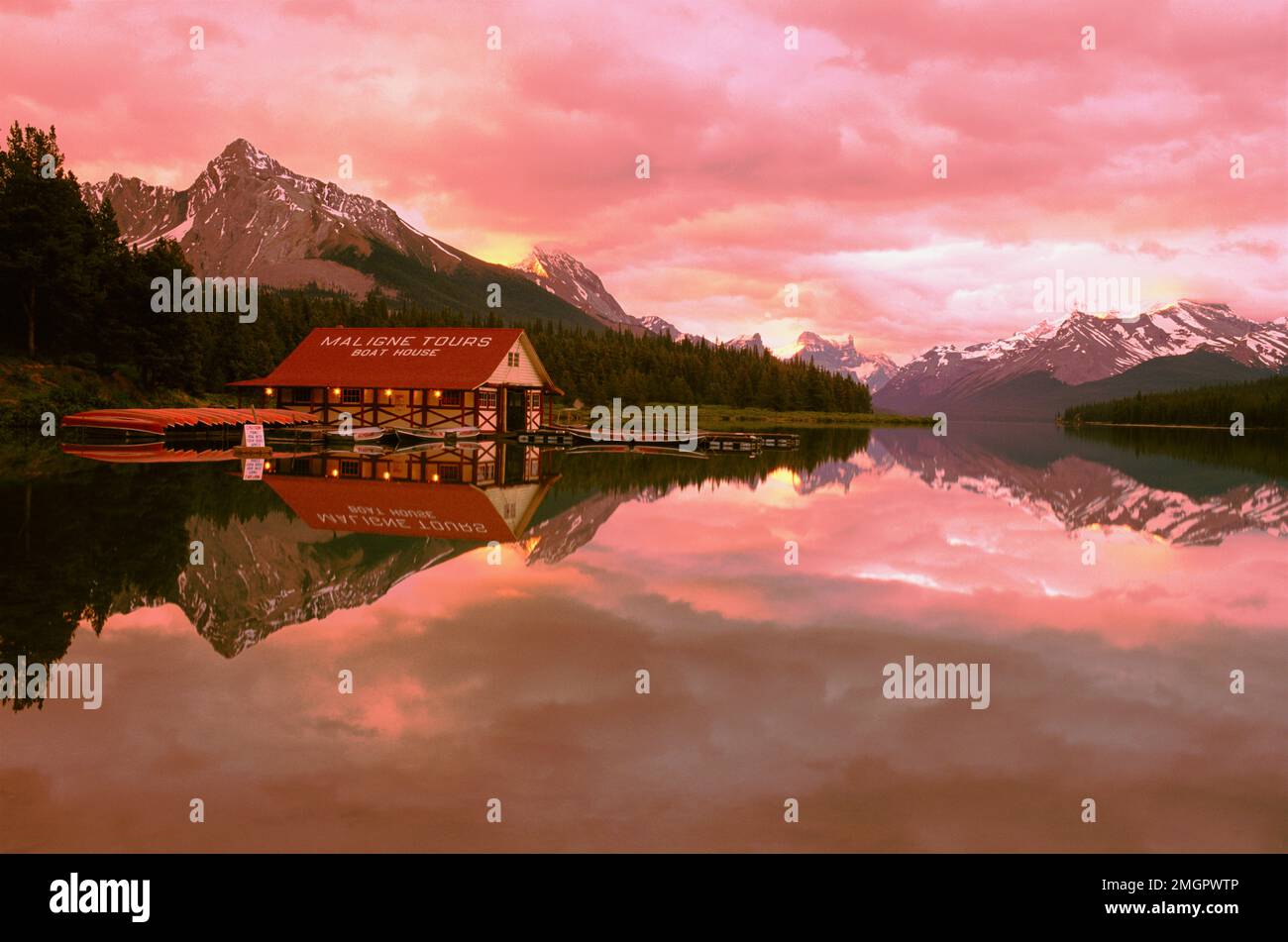 Canada, Alberta, Jasper, Maligne Lake, boathouse reflection on Maligne Lake at dawn Stock Photo