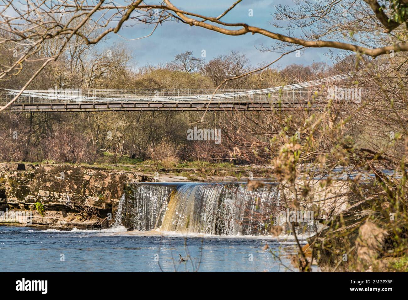 A cascade on the River Tees close to the Grade II* listed Whorlton Suspension Bridge, Teesdale, County Durham, UK Stock Photo