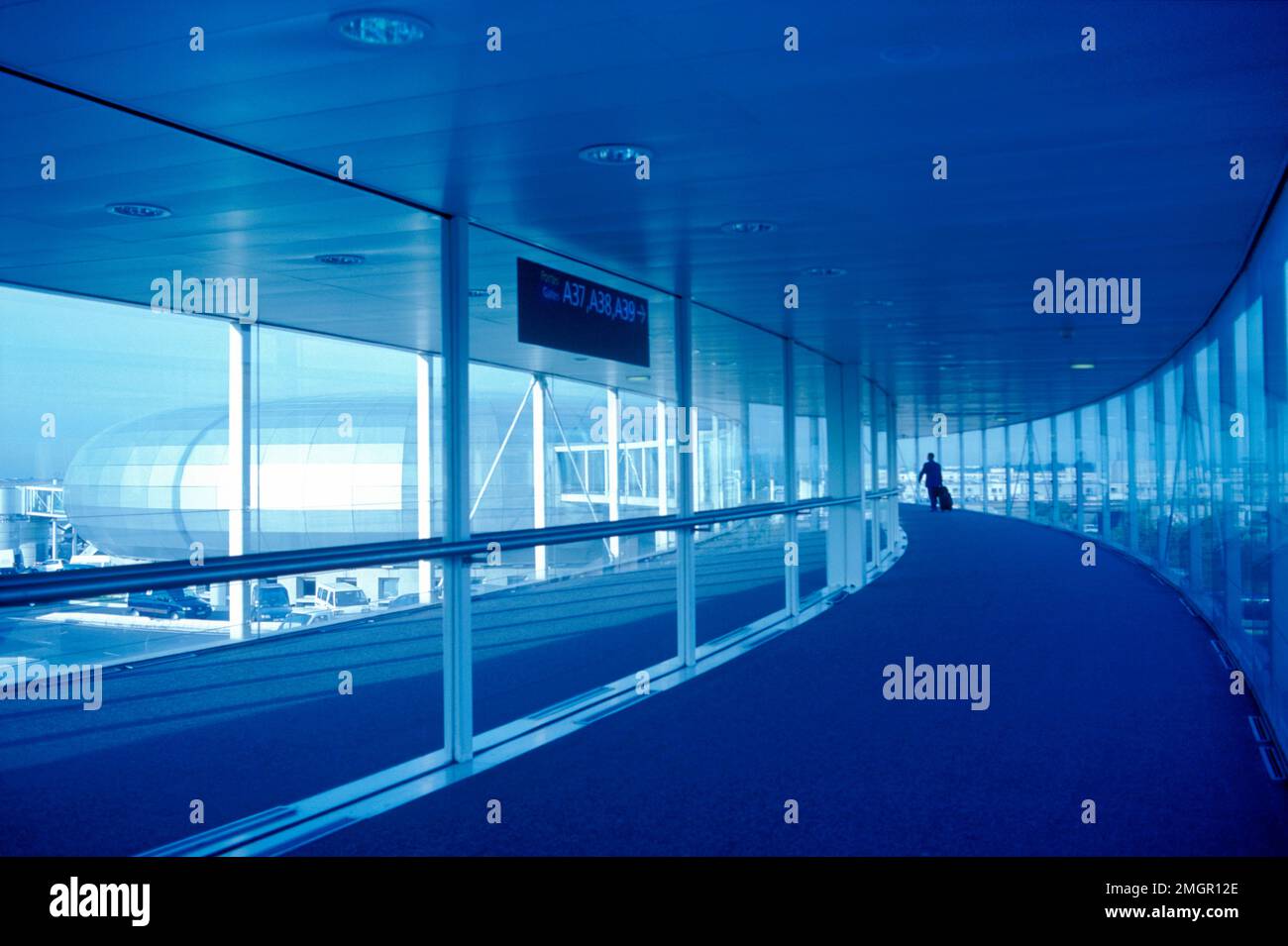 France, Paris. RoissyCharles de Gaulle Airport. Airport terminal walkway with one person