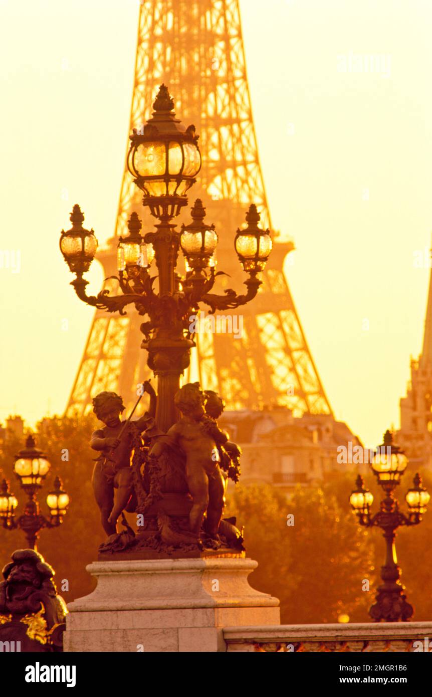 France, Paris, Ponte Alexandre, statuary of cherubs and lamp post with the Eiffel Tower in the back ground. Stock Photo