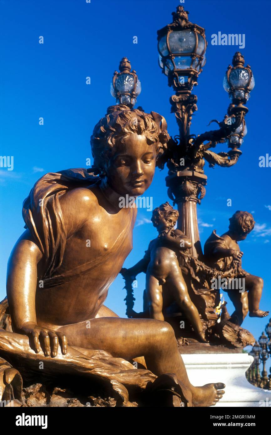 France,Paris,Pont Alexandre III,bronze cherub statues and lamp posts adorning bridge Stock Photo