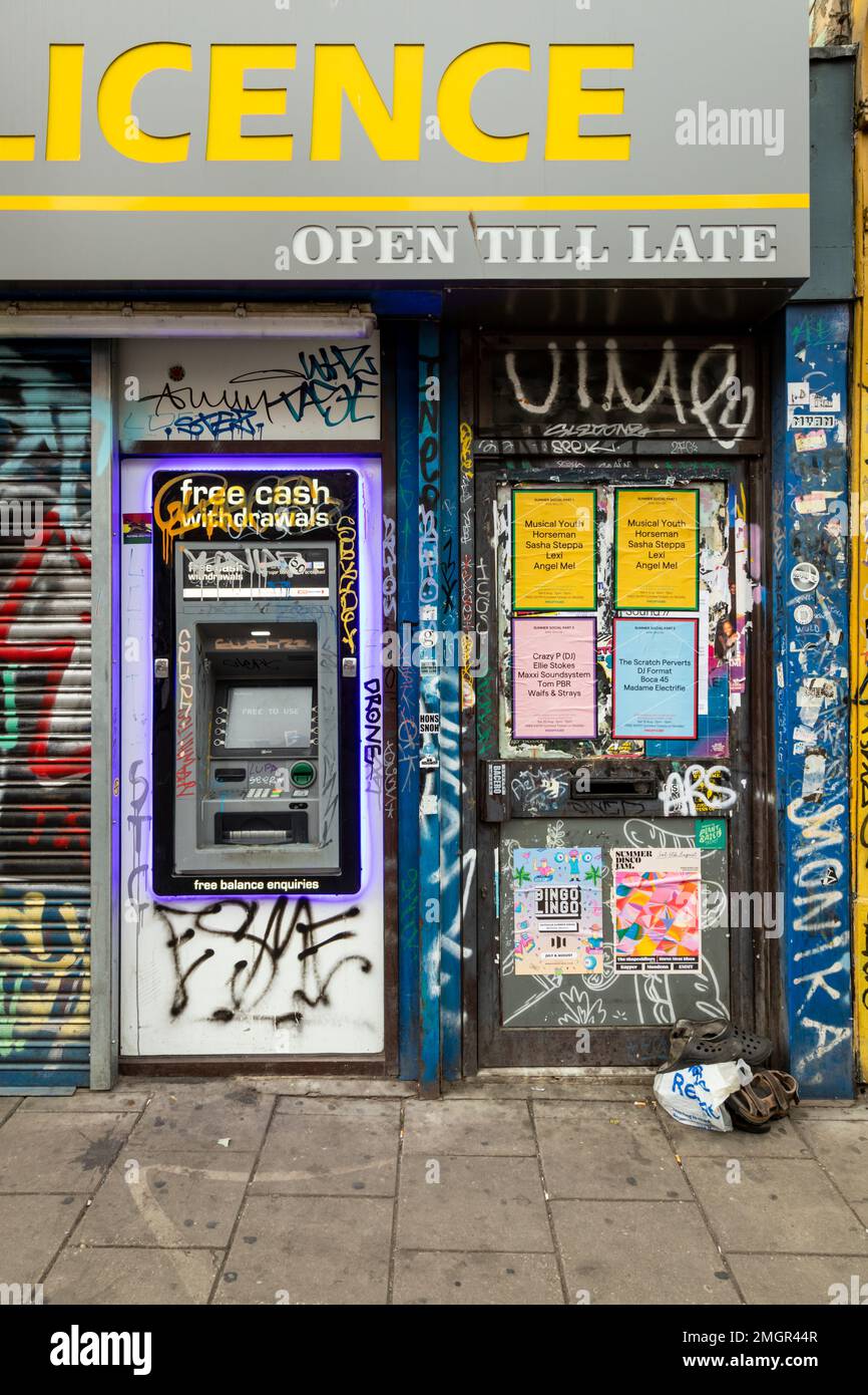 Cashpoint or ATM machine on a wall covered in graffiti, Bristol, UK Stock Photo