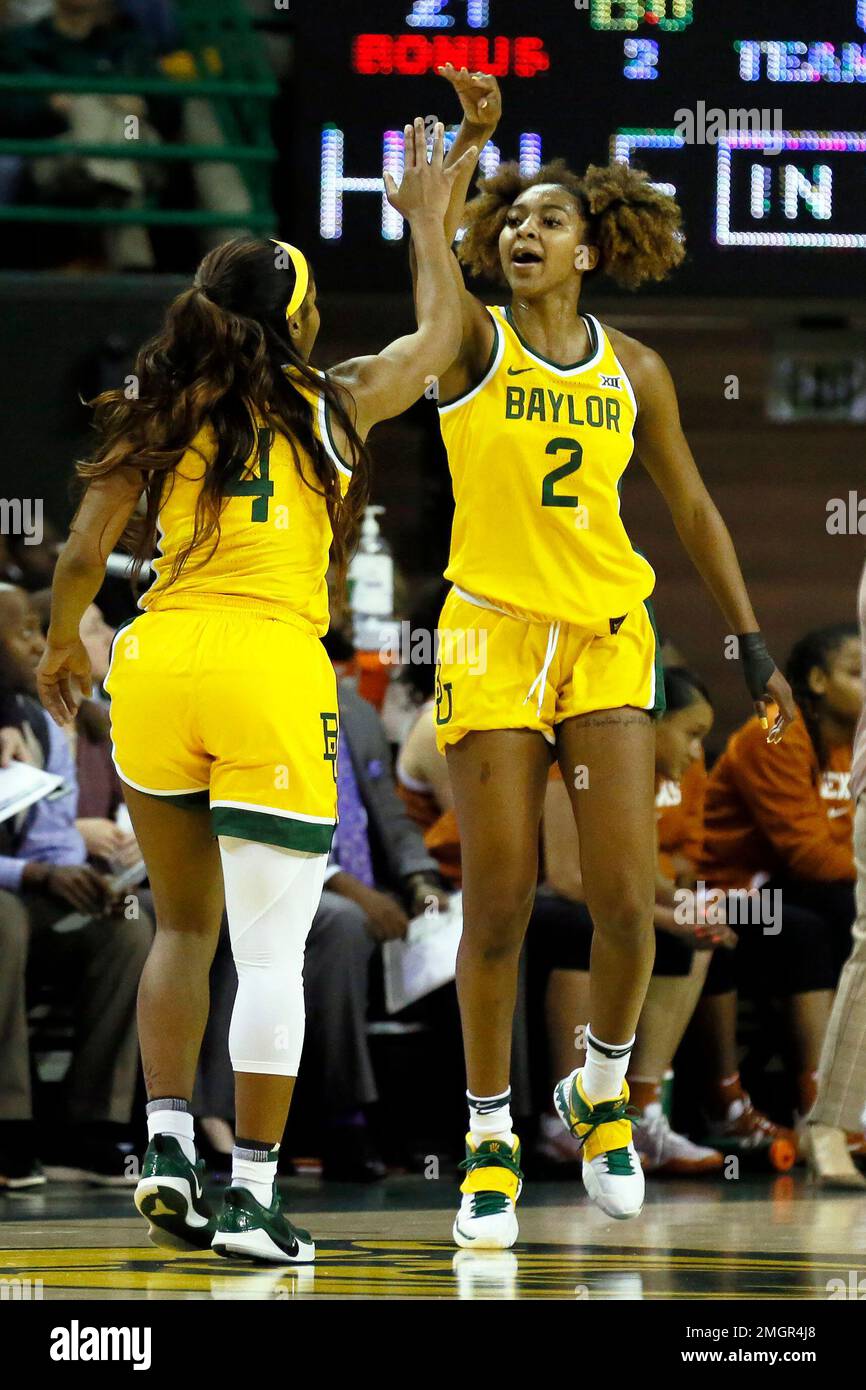Baylor guard Te'a Cooper, left, and guard DiDi Richards, right, high