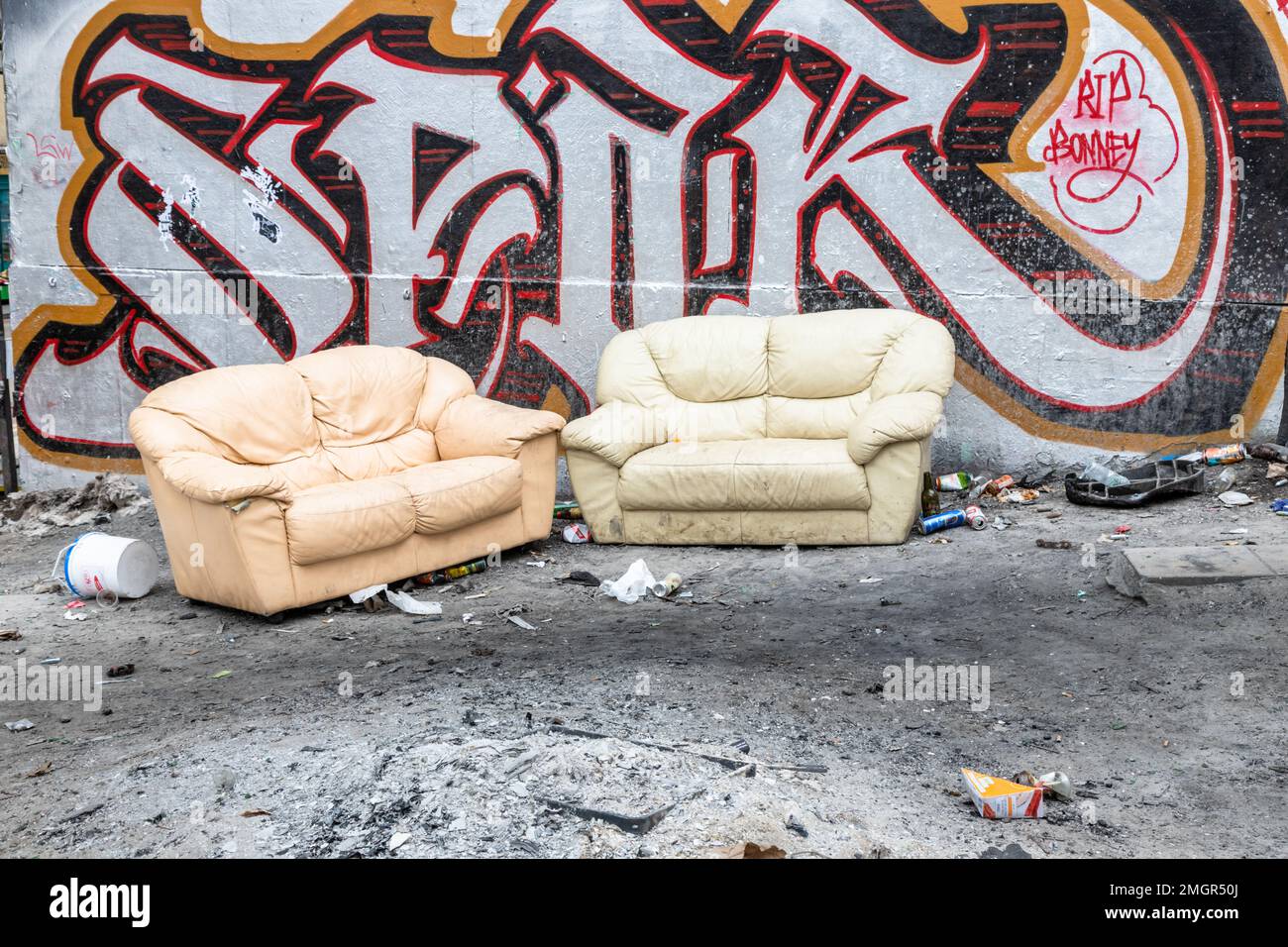 Two old sofas dumped in a street, Bristol UK Stock Photo