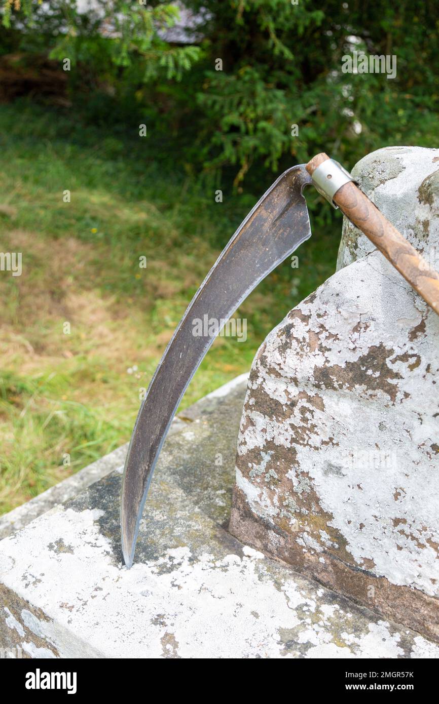 An Image Of A Dark Blade In Grass Background, Picture Of Scythe