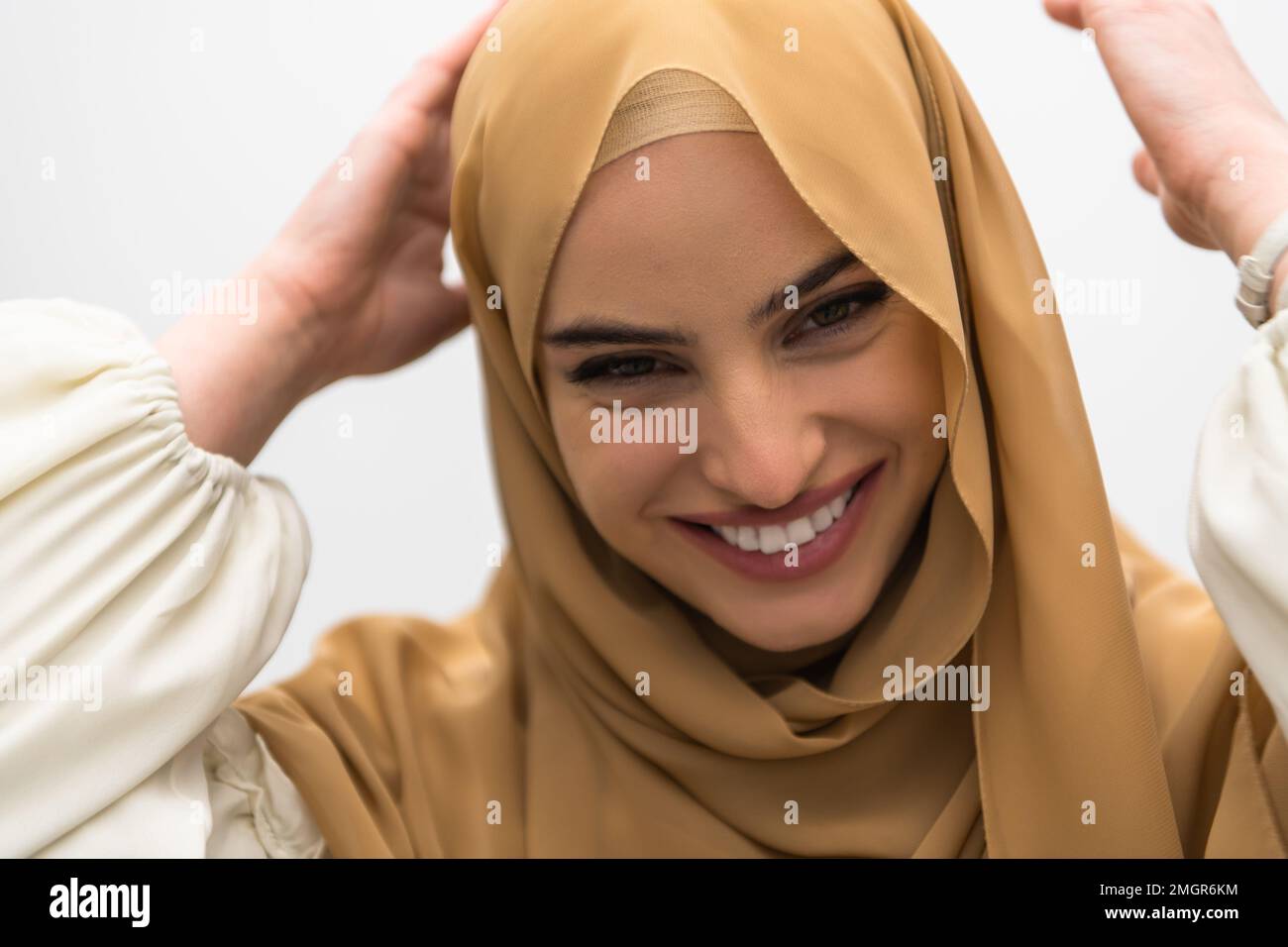 Portrait of young muslim woman wearing hijab on isolated white ...