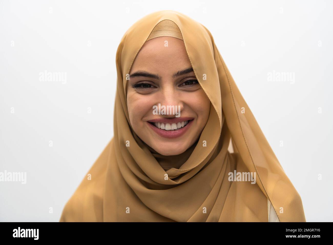 Portrait of young muslim woman wearing hijab on isolated white ...