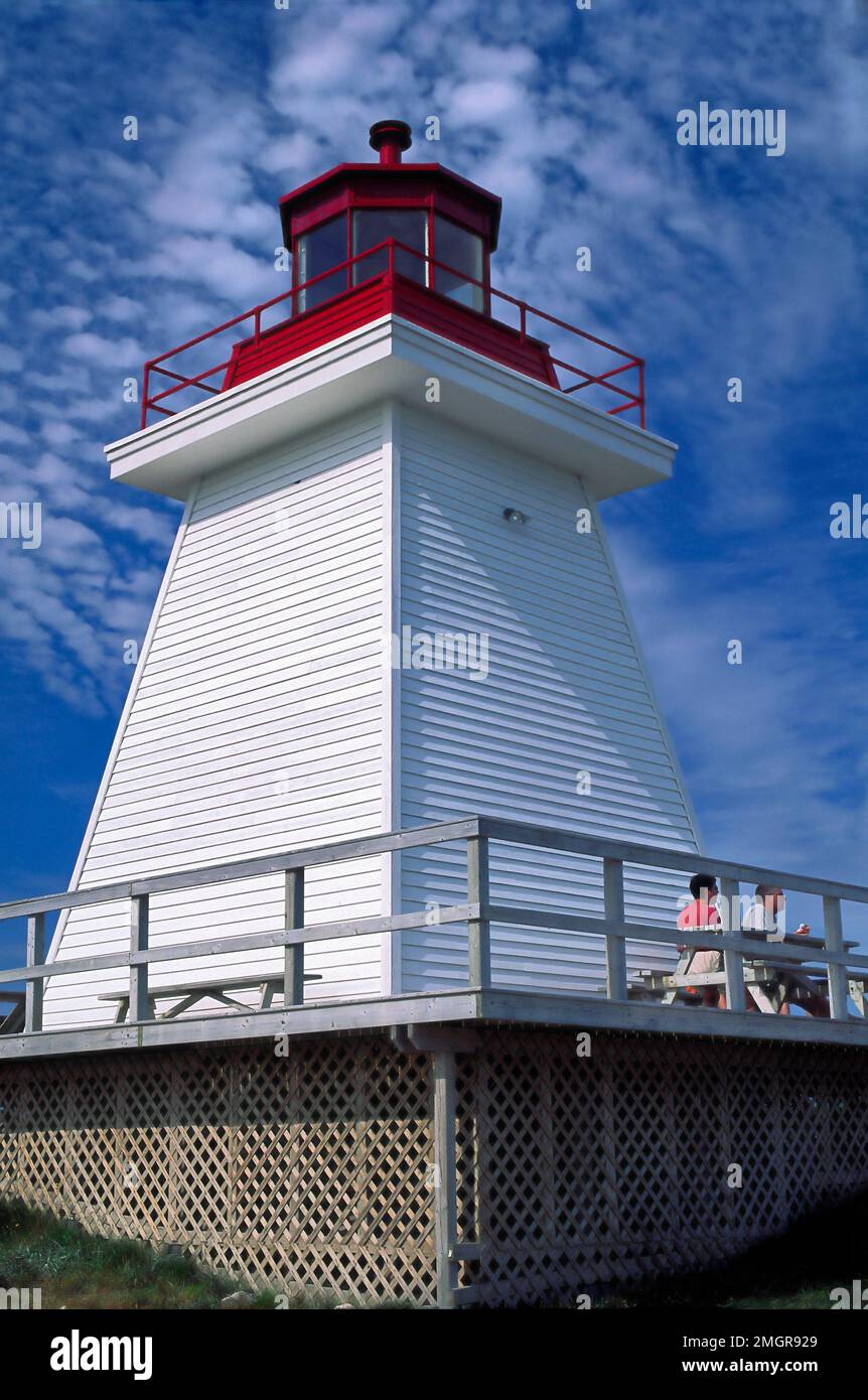 Neil's Harbour Lighthouse, pyramid shape, white, red top, 2 people