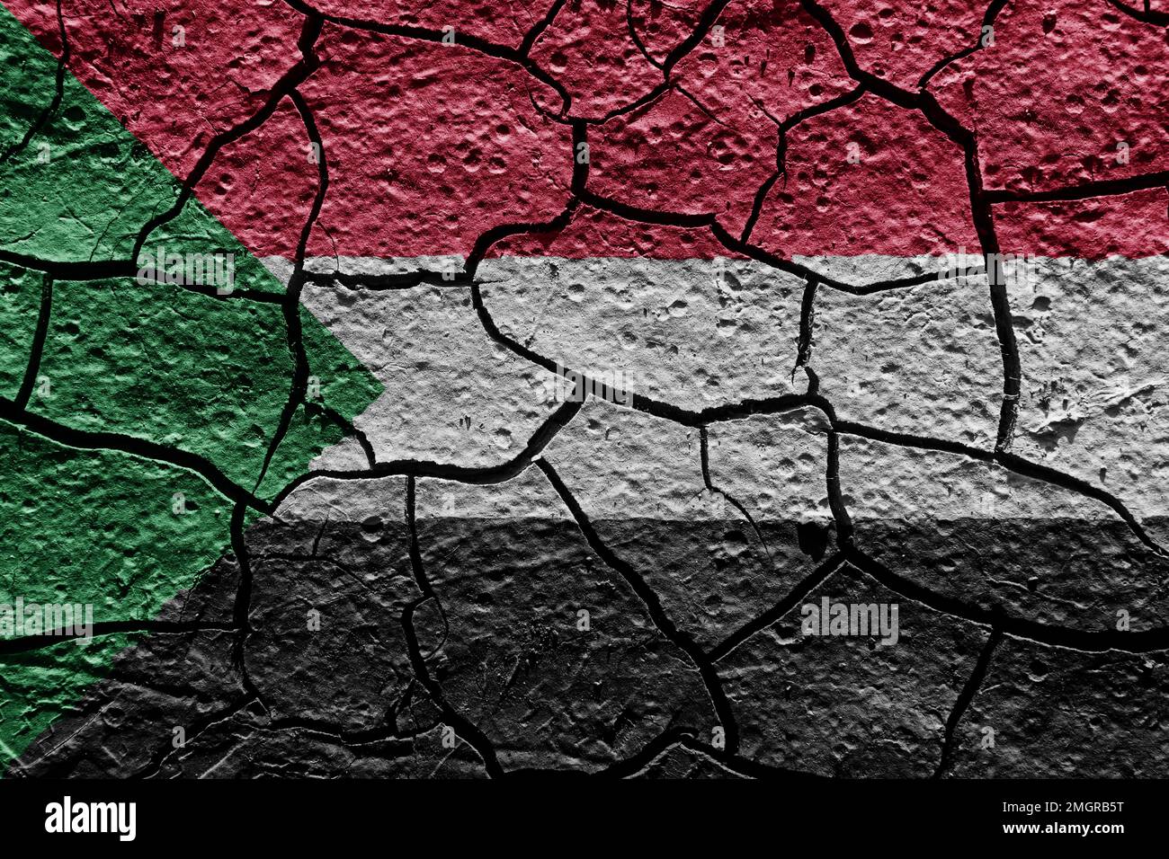 Sudan flag on a mud texture of dry crack on the ground Stock Photo