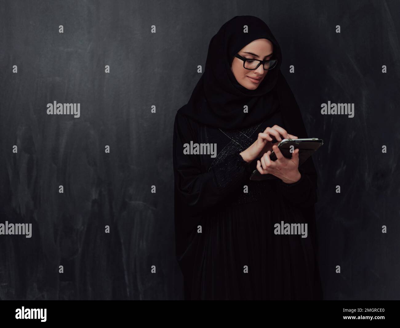 Young modern muslim business woman using smartphone wearing hijab ...