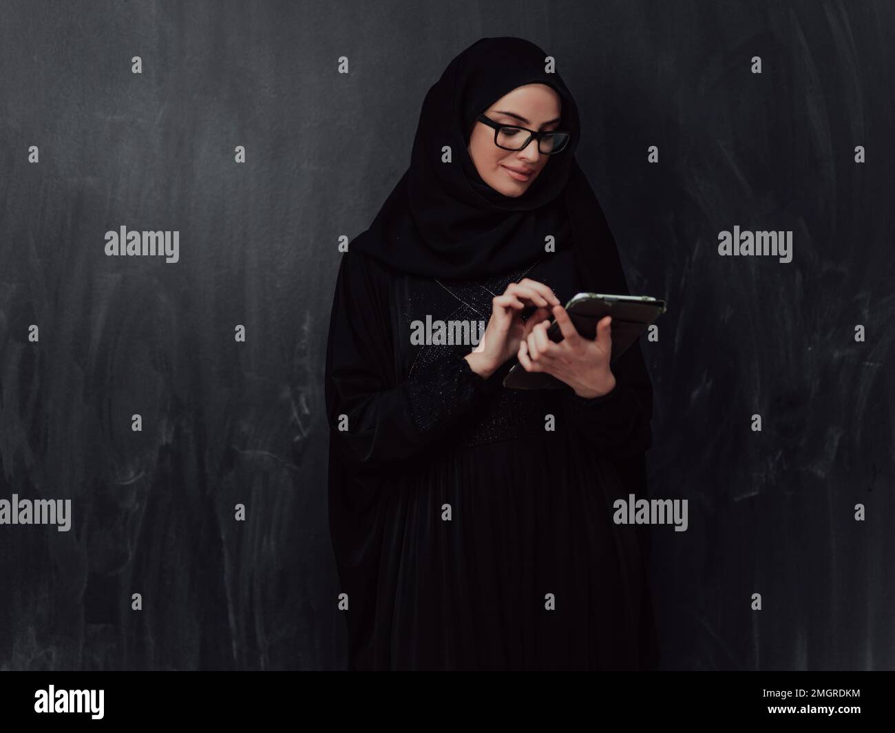 Young modern muslim business woman using smartphone wearing hijab ...