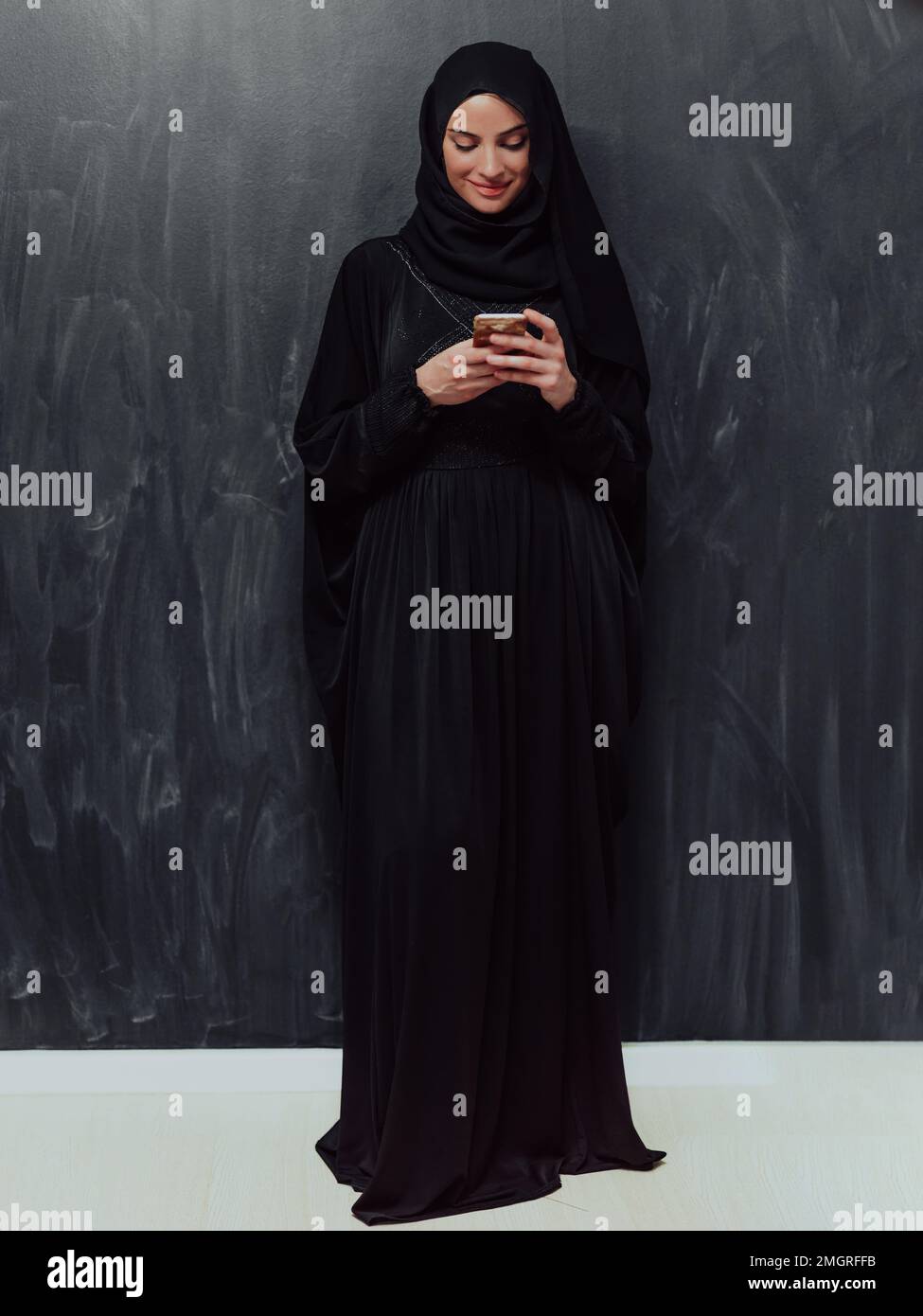 Young modern muslim business woman using smartphone wearing hijab ...