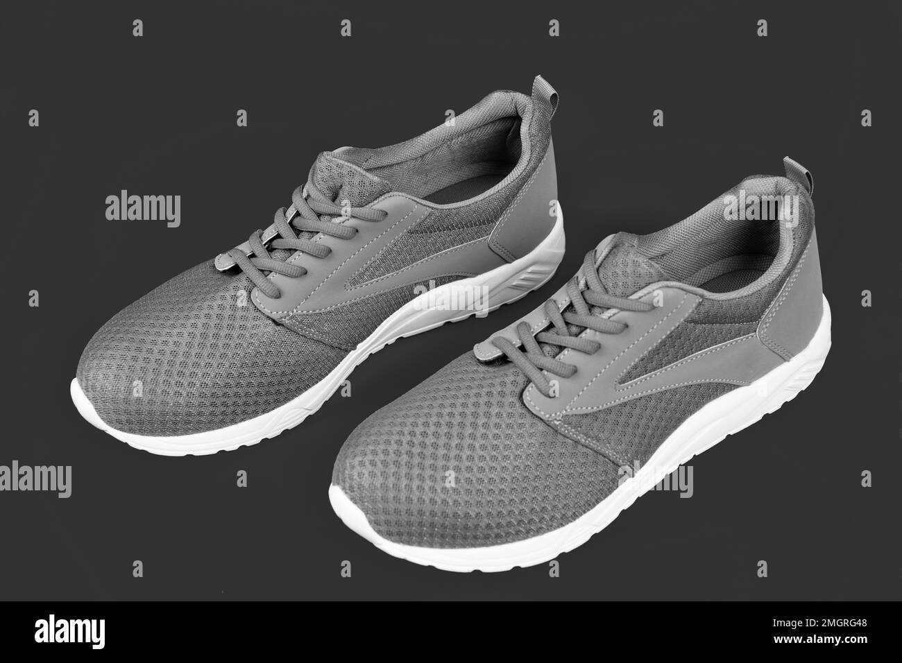 sporty blue sneakers pair on pink background, sport fashion Stock Photo