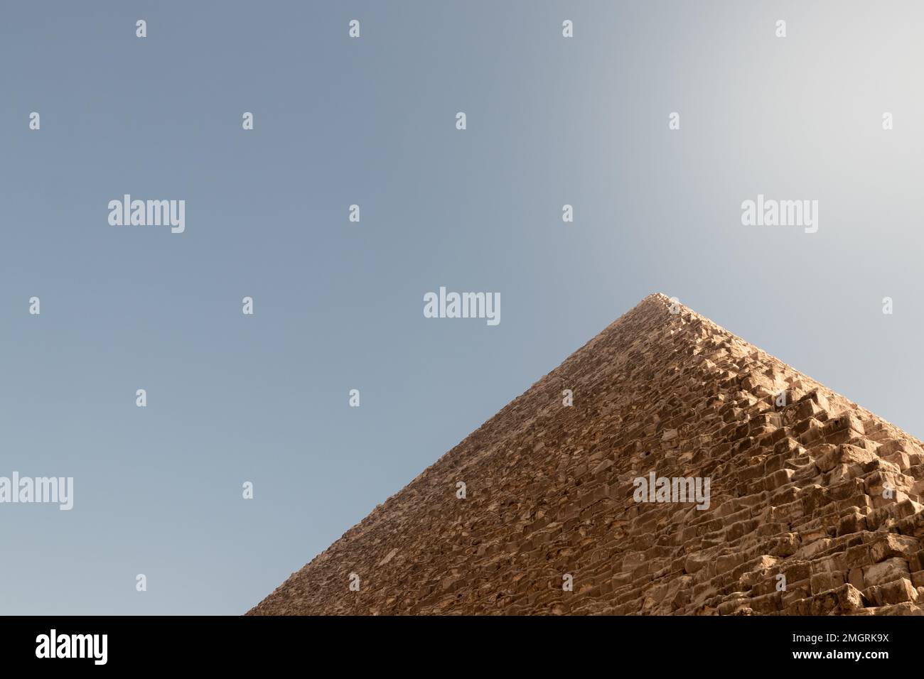 Low angle cropped view of the great Giza pyramid with blue clear sky ...