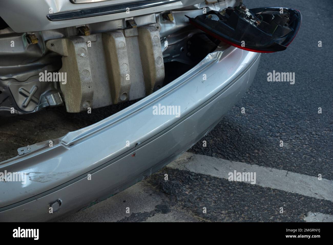 The rear bumper of the car was damaged and tail light fell off after being hit from the rear