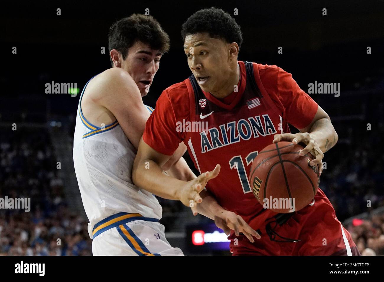 Arizona forward Ira Lee, right, drives around UCLA guard Jaime Jaquez Jr.  during the first half of an NCAA college basketball game in Los Angeles,  Saturday, Feb. 29, 2020. (AP Photo/Chris Carlson