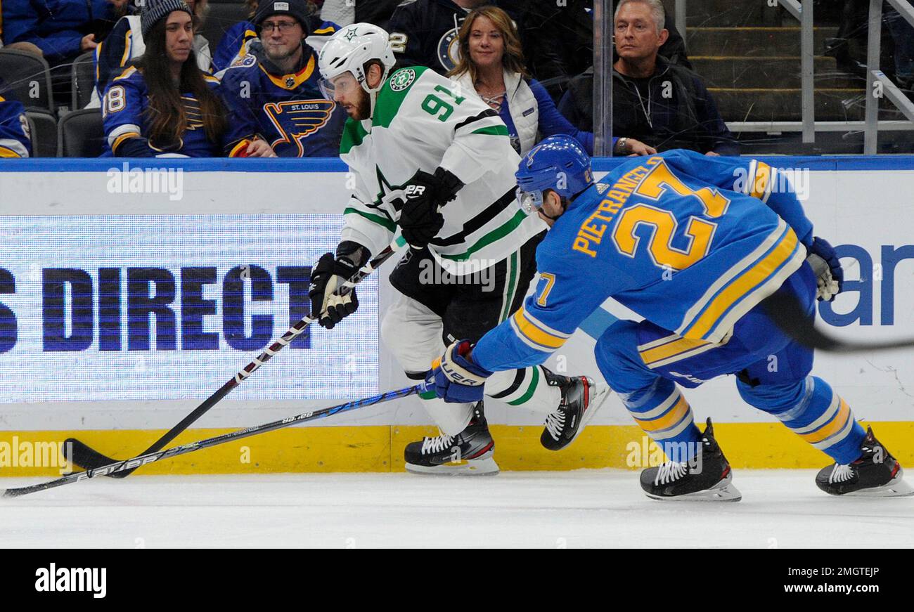 St. Louis Blues' Alex Pietrangelo (27) reaches for the puck with Dallas  Stars' Tyler Sequin (91) during the first period of an NHL hockey game,  Saturday, Feb. 29, 2020, in St. Louis. (