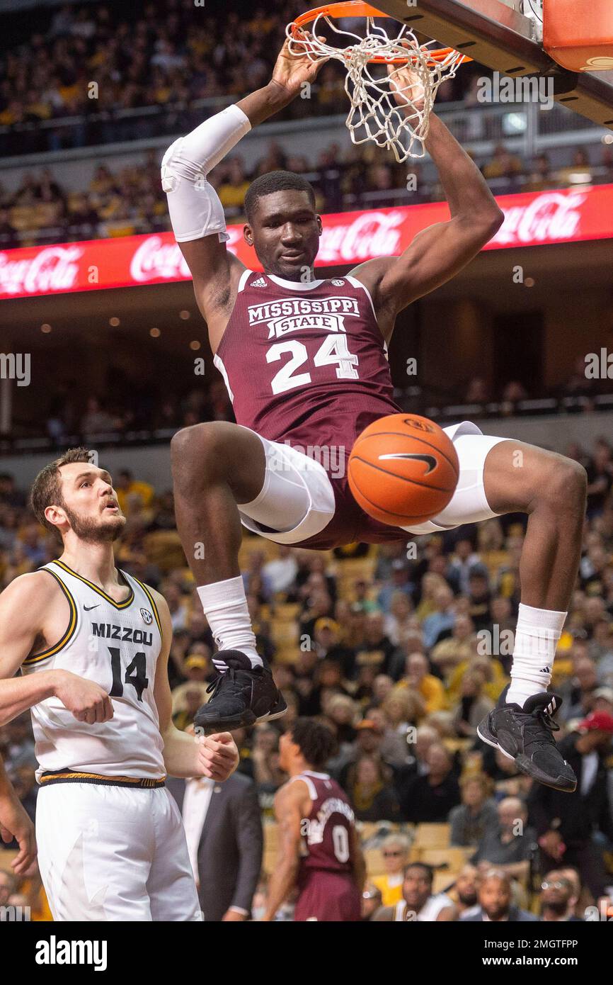 Mississippi State s Abdul Ado right dunks the ball over