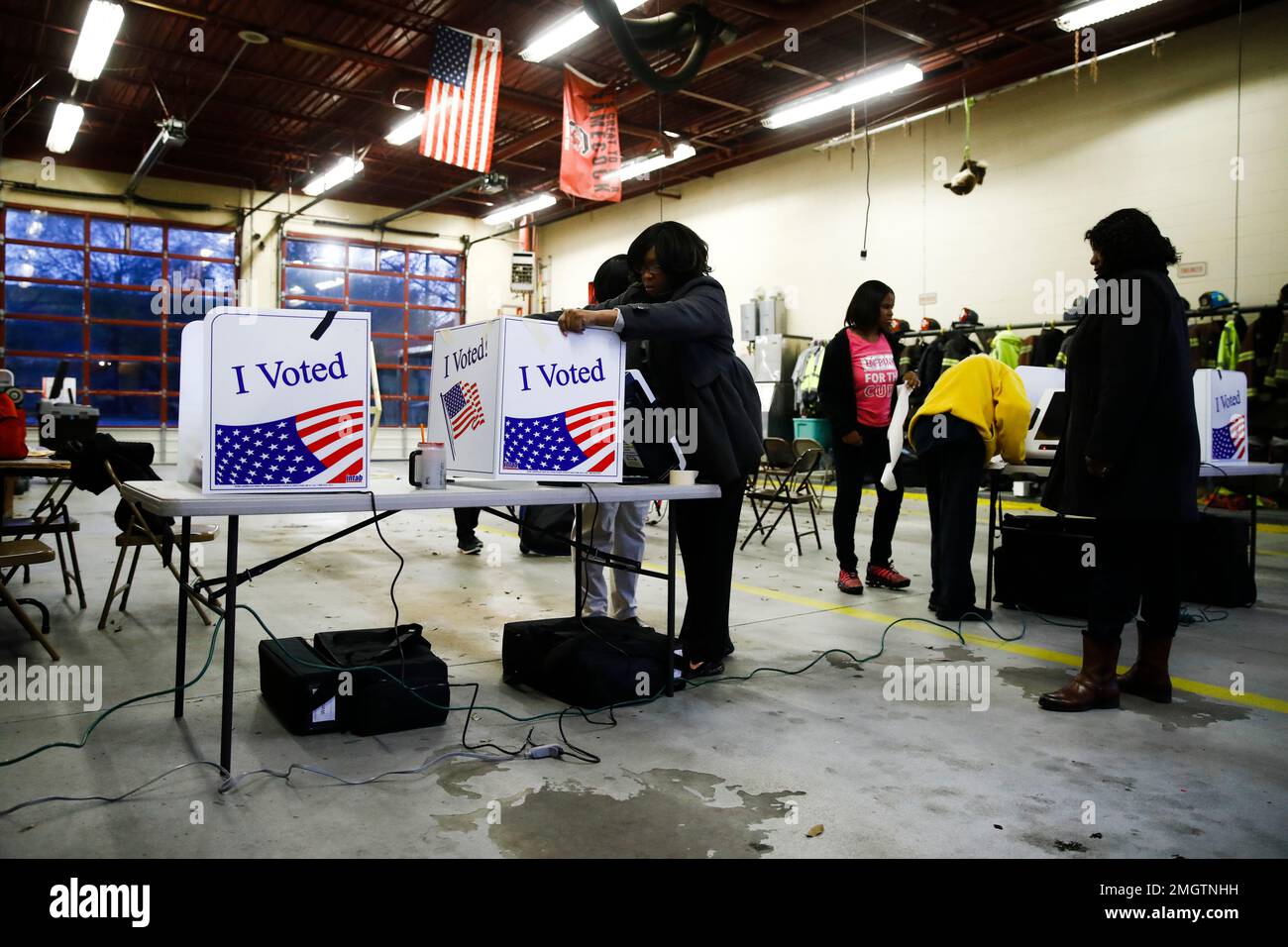 Workers prepare a polling place before voter cast their ballots in the