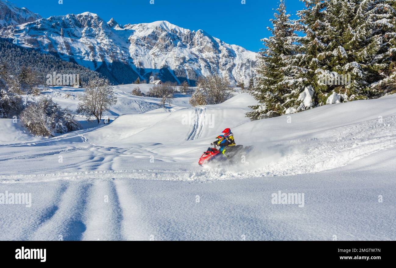 Man on snowmobile in snowy landscape -the Adamello Brenta Natural Park, Trentino Alto Adige, northern Italy, Europe Stock Photo