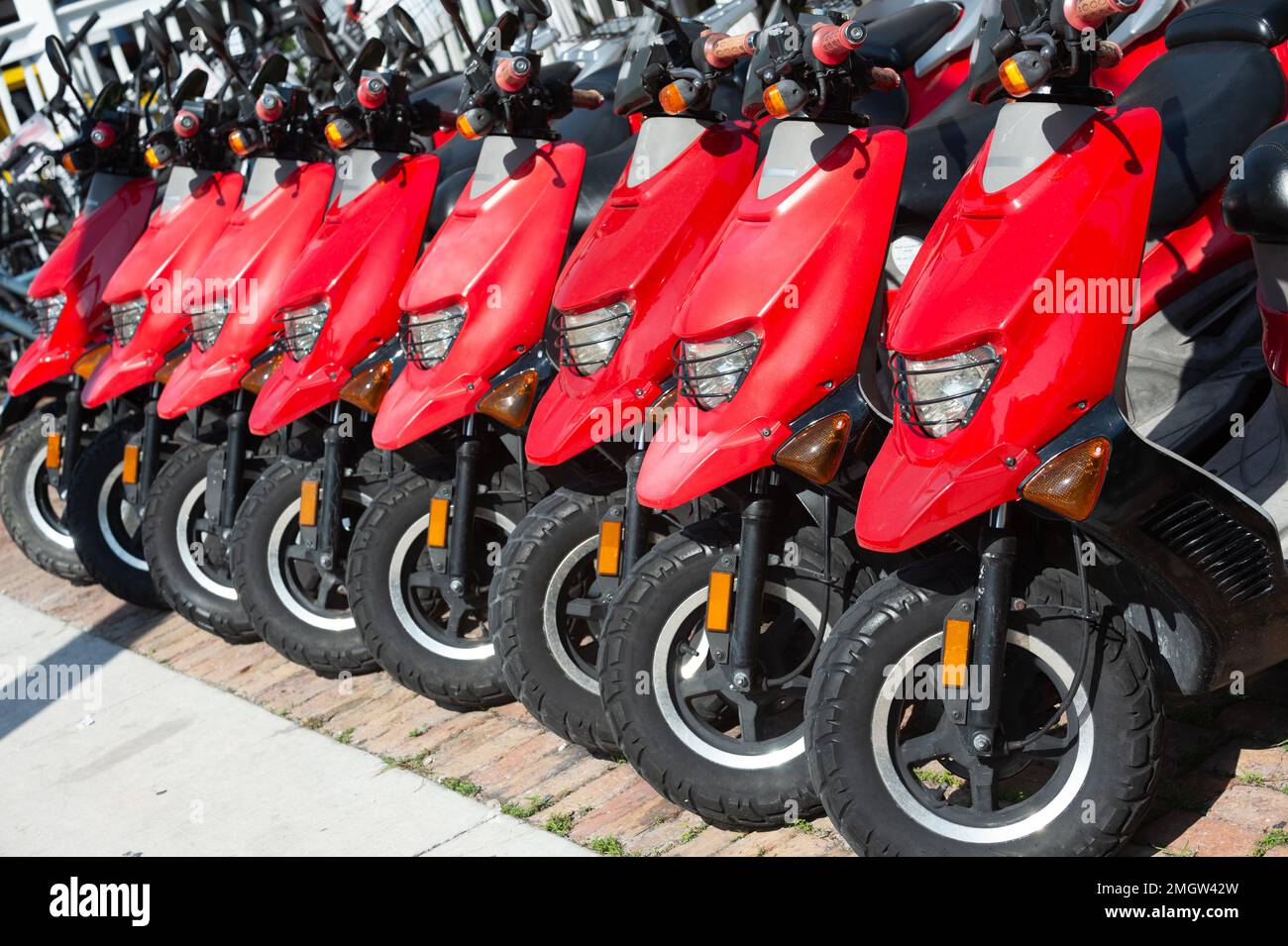 parked rental moped outdoor, corner view. photo of parked rental moped
