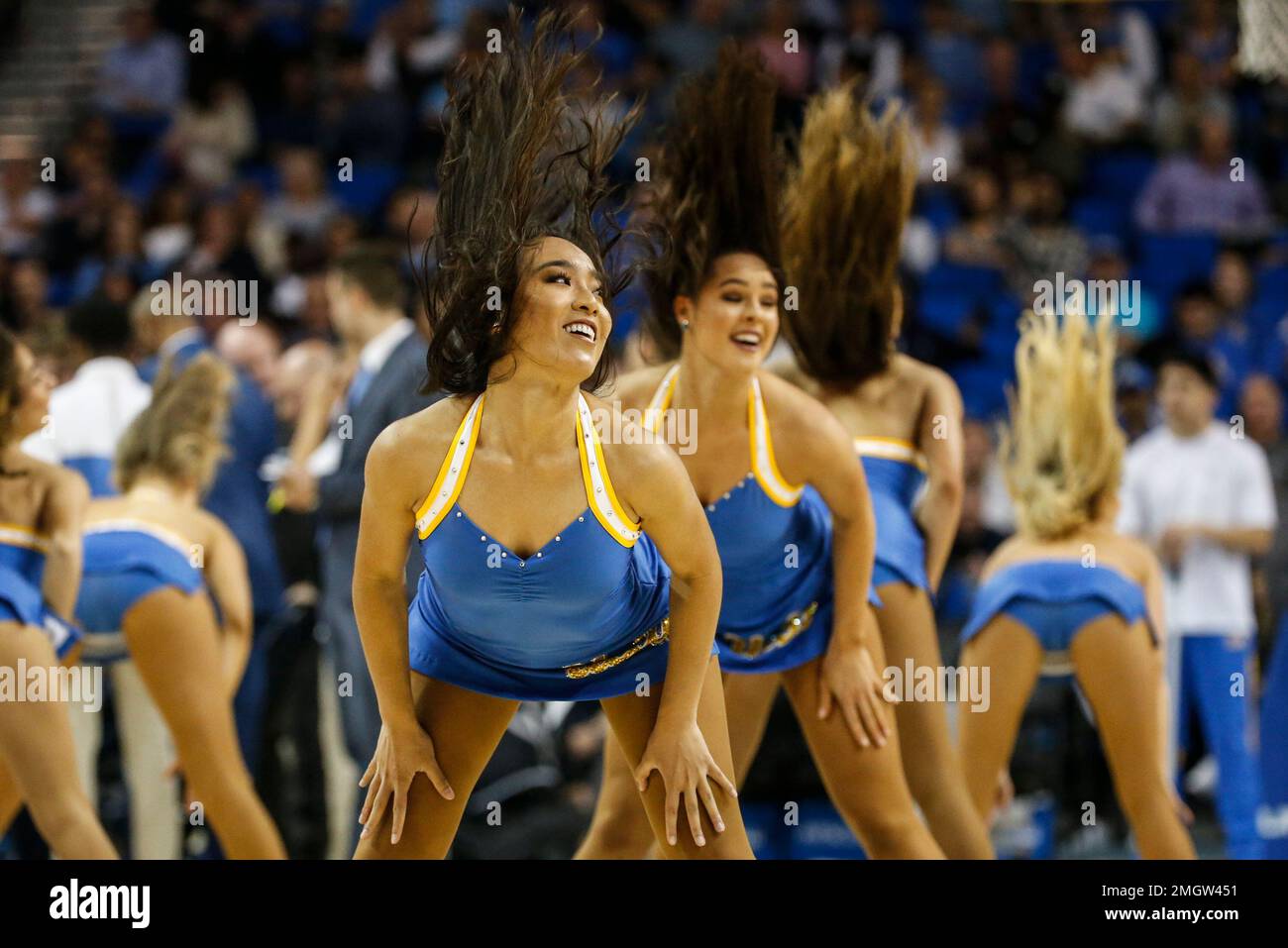UCLA cheerleaders perform during an NCAA college basketball game