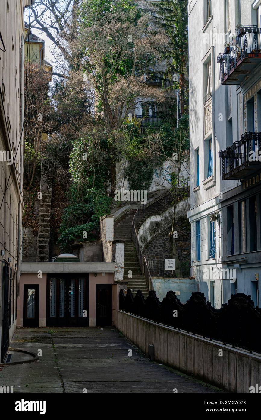 a residential building with terraces in the middle with vegetation and a small house on the side on a sunny day Stock Photo