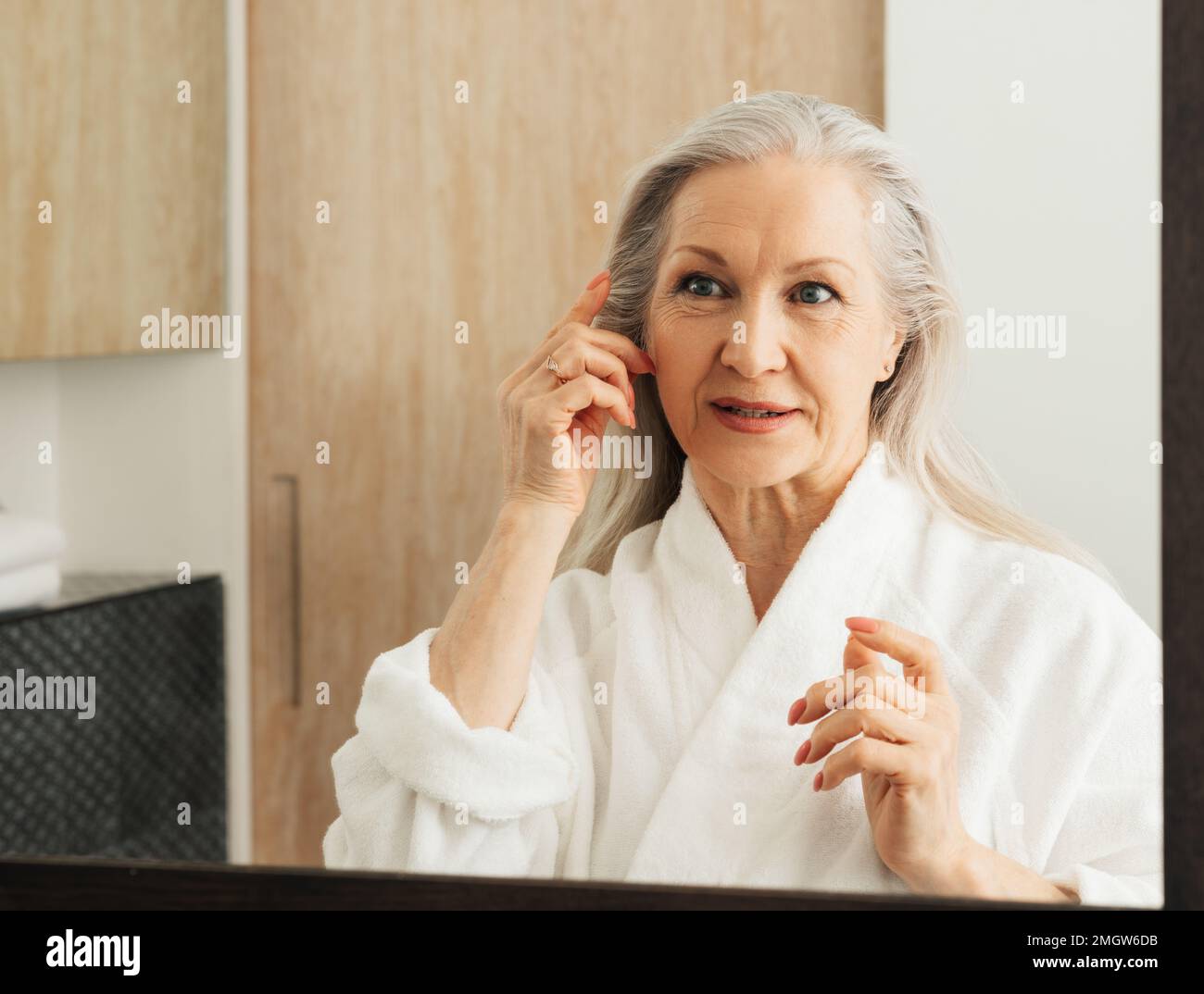 Woman looking her hair hi-res stock photography and images - Alamy
