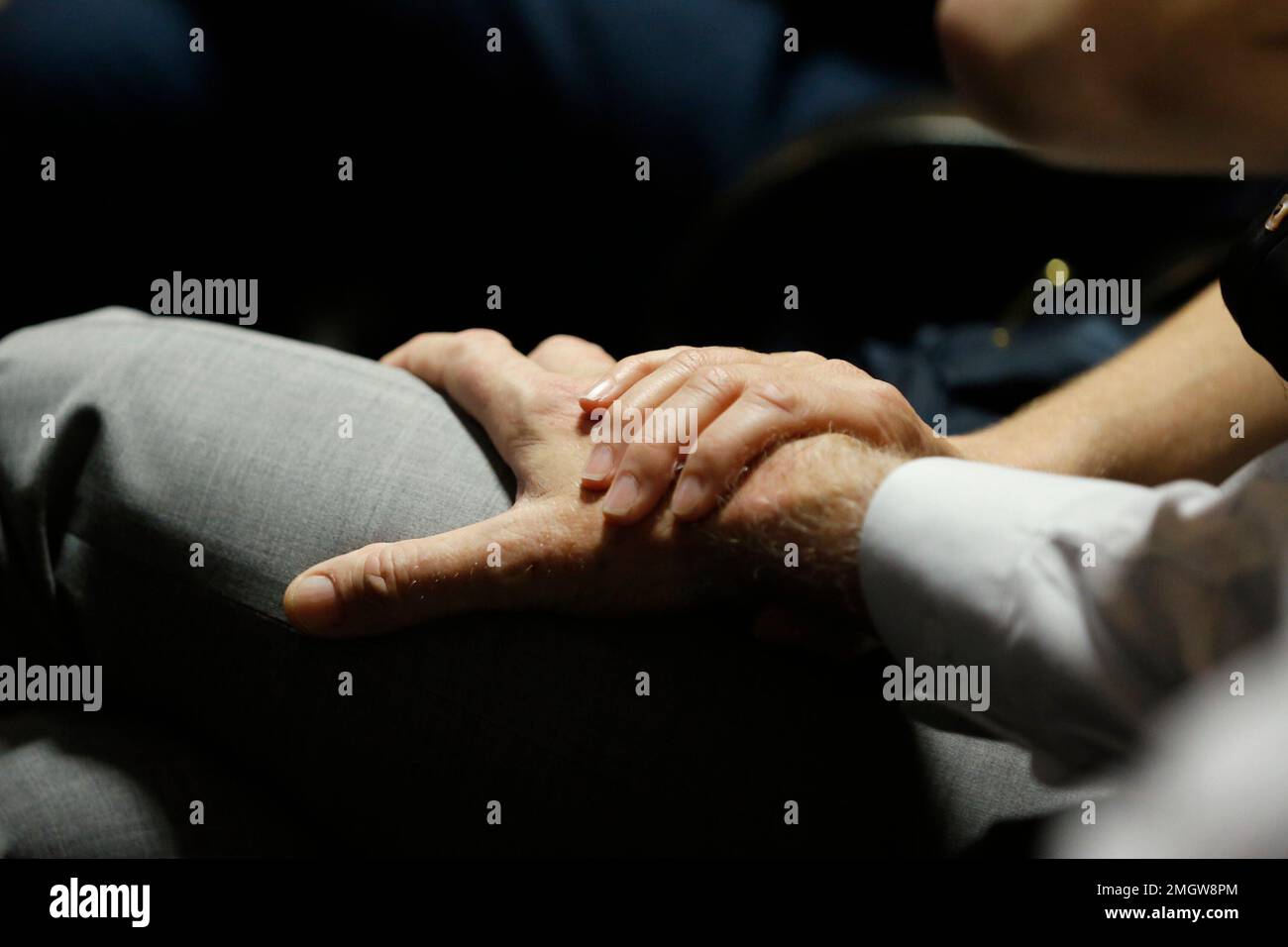 Ethan Elder, father of Finnegan Lee Elder, holds hands with his wife