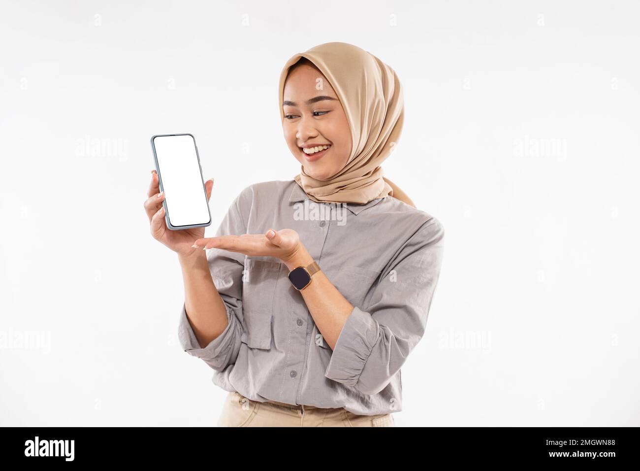 a beautiful woman with hijab standing with smile and showing the phone ...