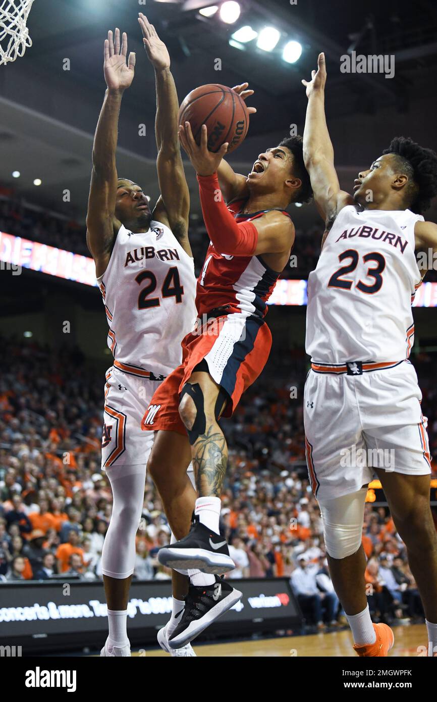 Mississippi guard Breein Tyree (4) shoots while defended by Auburn