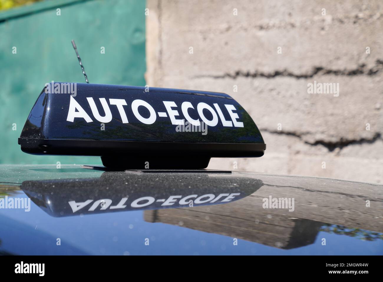 driving school means auto ecole text sign in french write on education learning car roof Stock Photo