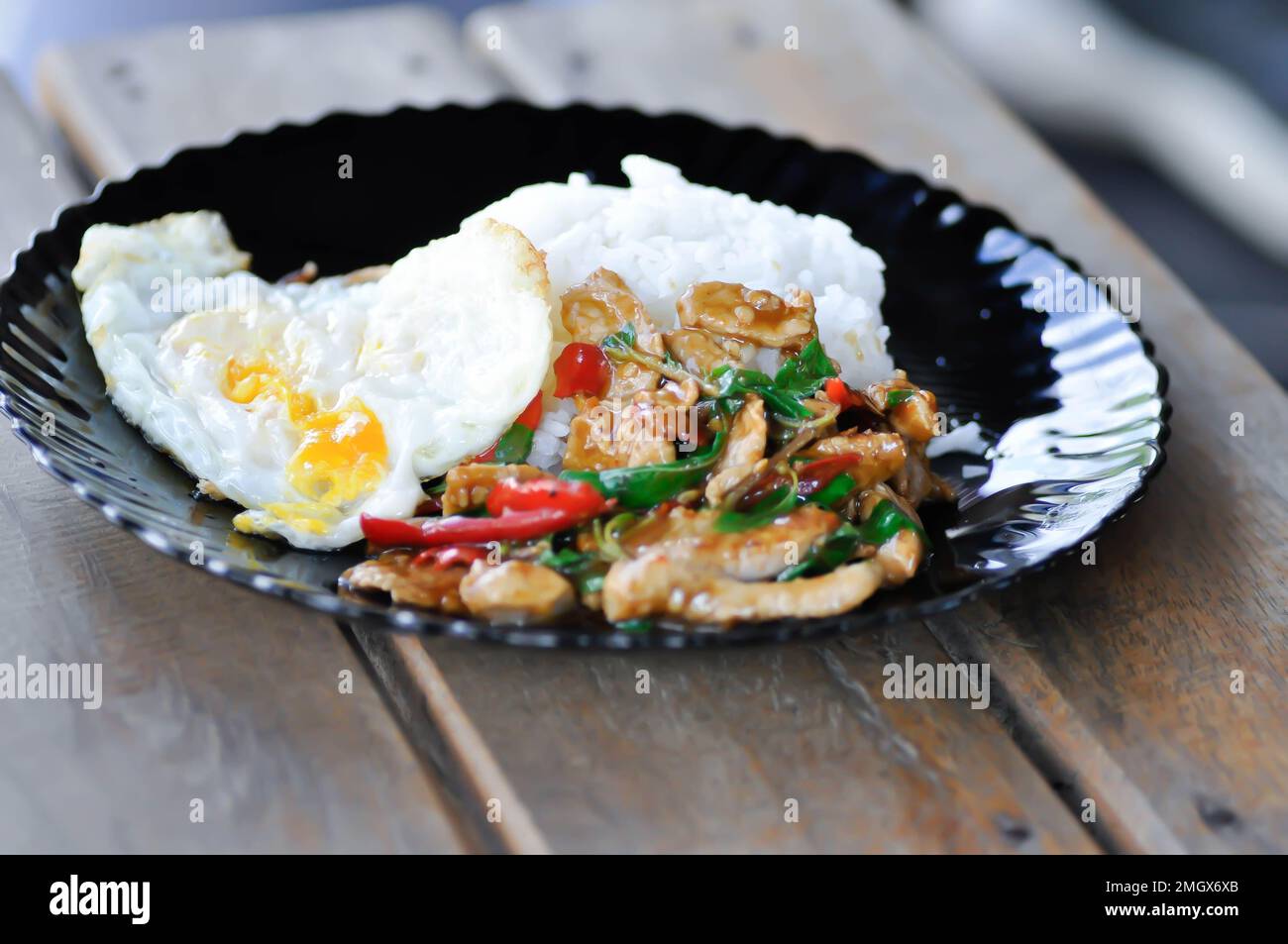 stir fried pork or stir fried pork with chili paste with rice and sunny side up egg or spicy pork Stock Photo