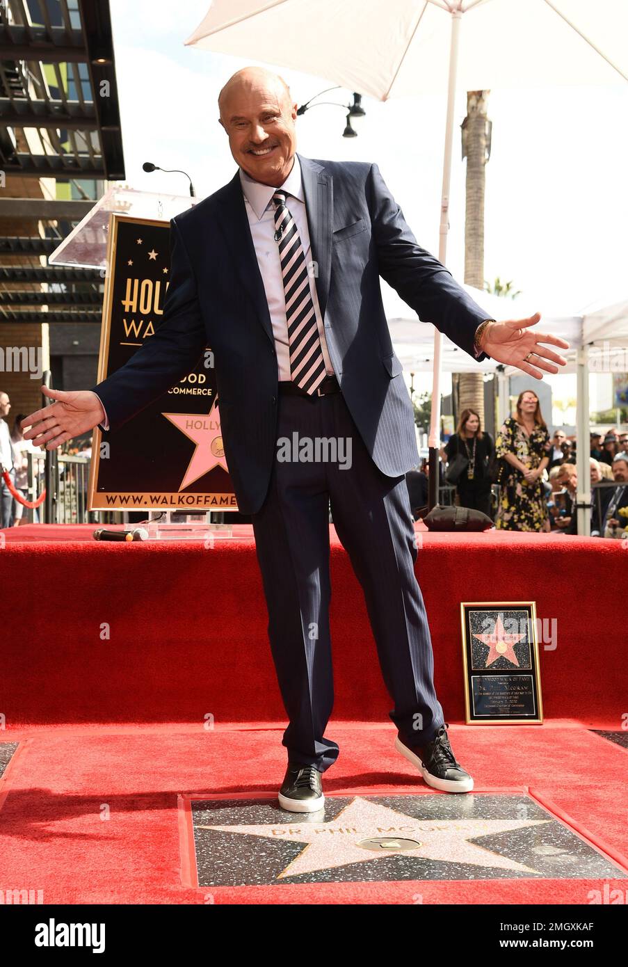 Talk show host Dr. Phil McGraw poses atop his new star on the Hollywood